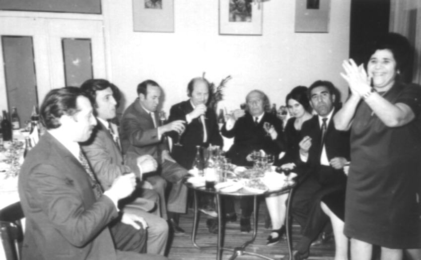 Ե. Քոչարը , կինը՝ Մ. Մկրտչյանը և մի խումբ մարդիկ փոքրիկ սեղանի շուրջ,  [1970–ականներ]