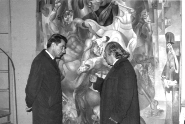 Ե. Քոչարը  Գրիգոր  Հասրաթյանի հետ իր արվեստանոցում՝ «Պատերազմի արհավիրքը» կտավի առջև զրուցելիս, 1971